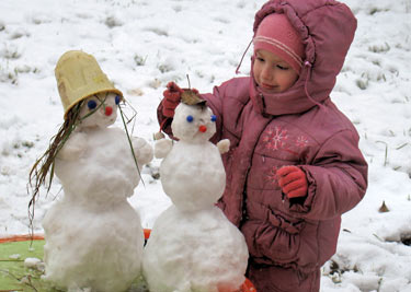 дети лепят снеговика